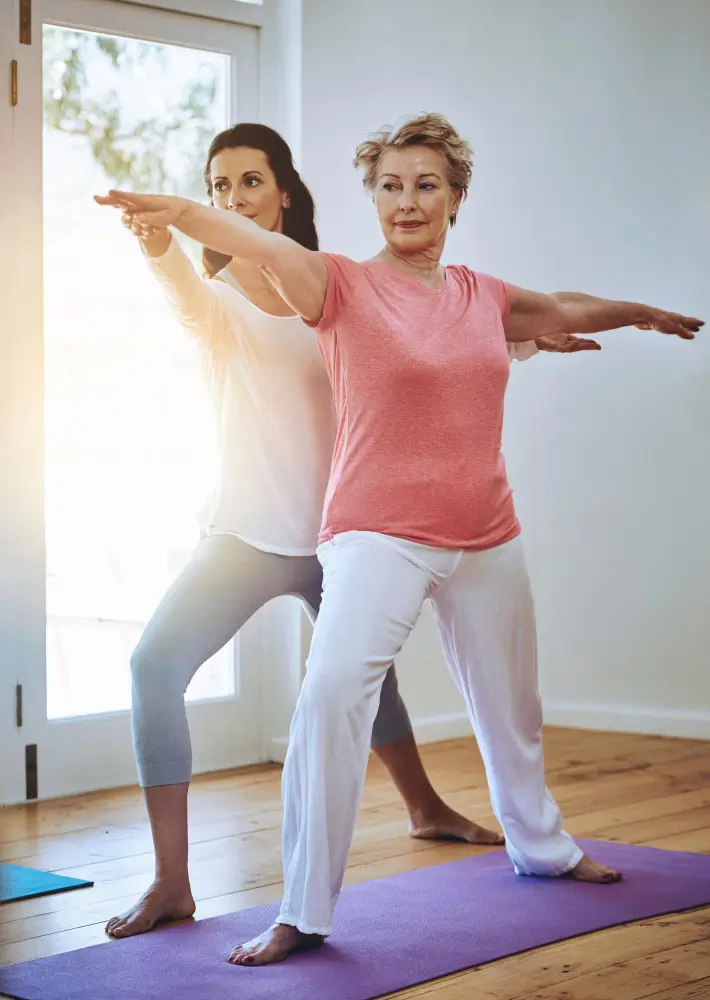 Woman and client performing yoga pose for body transformation coaching in Thames Ditton.