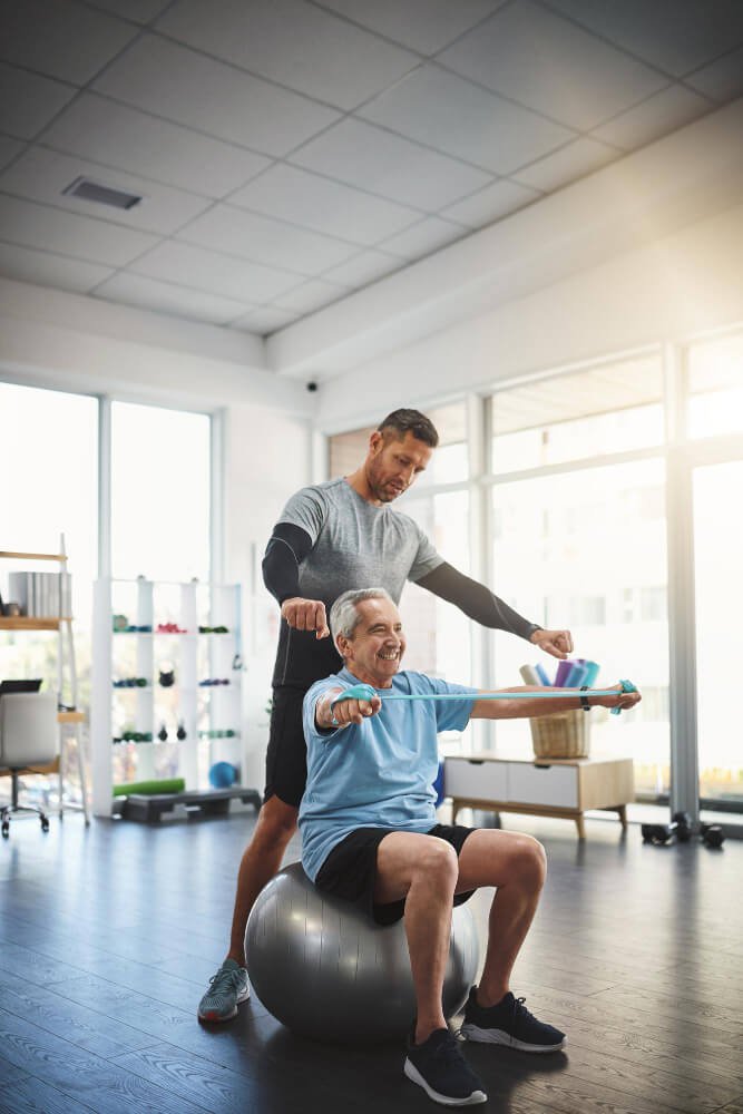 Senior fitness training with personal trainer, low-impact strength and mobility exercise.